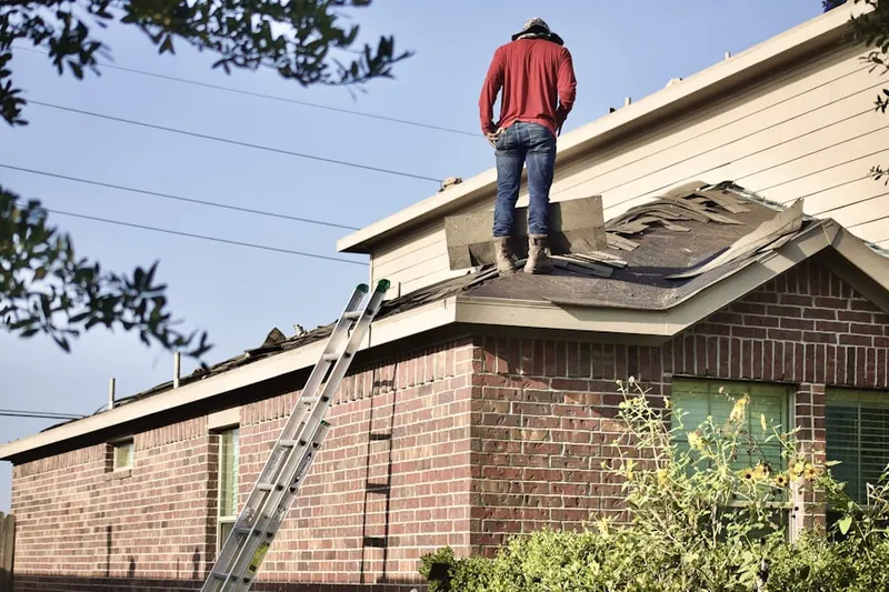 Professional roofer working on a residential roof in Dixon Branch